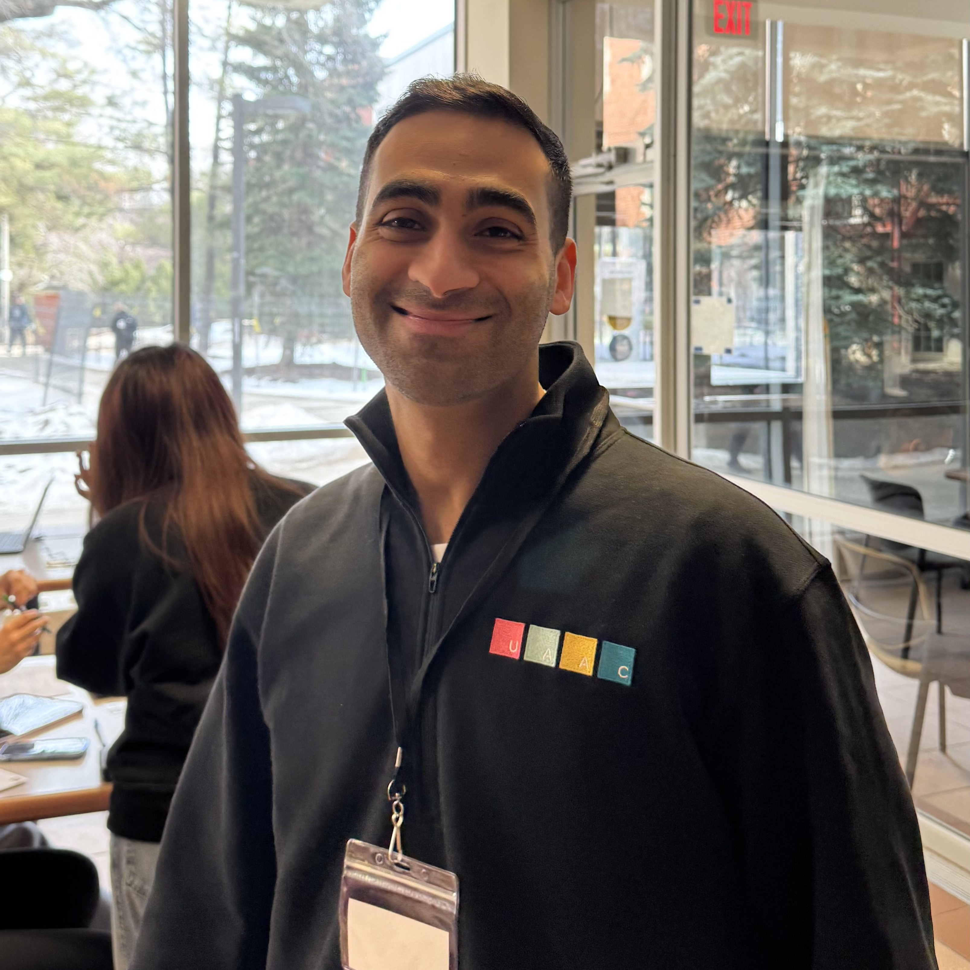 UAAC volunteer smiling for the picture, wearing a UAAC sweater