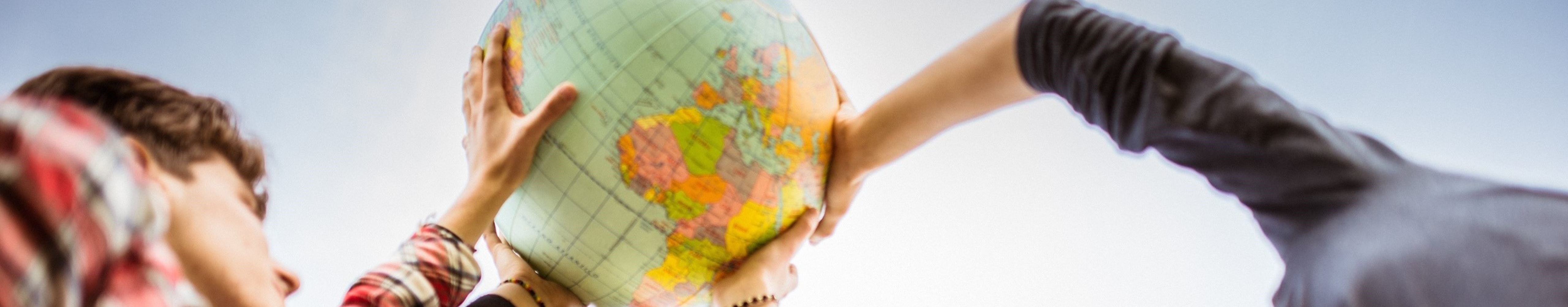 Students holding globe