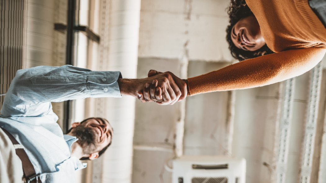 A man and woman shaking hands